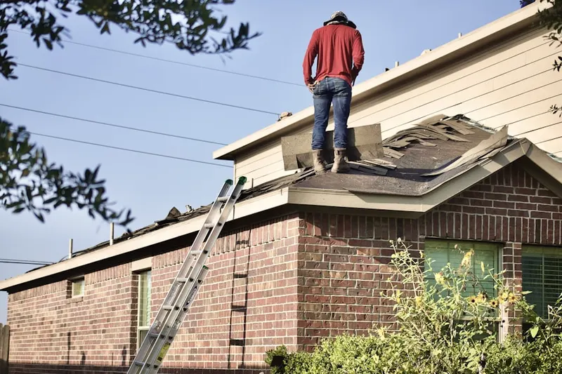 Professional roofer working on a residential roof in Table Mesa South